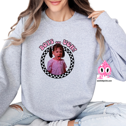 A person wearing a gray sweatshirt with a  black checkered pattern and the text 'BOYS... UGH!' printed on the front.
