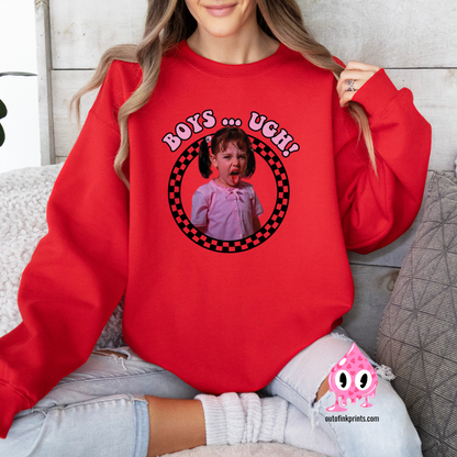 A person wearing a red sweatshirt with a pink and black checkered pattern and the text 'BOYS... UGH!' printed on the front.