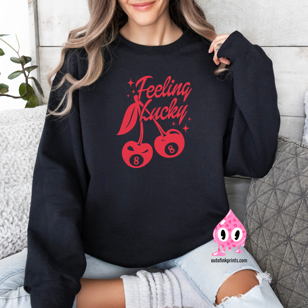 Front view of a black sweatshirt with a red 'Feeling Lucky' text and cherry graphics