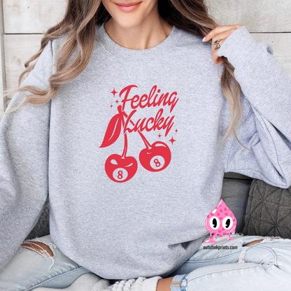 Front view of a grey sweatshirt with a red 'Feeling Lucky' text and cherry graphics