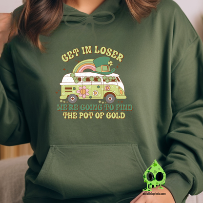 A person wearing a green hoodie with a graphic that includes a green four-leaf clover and text related to St. Patrick's Day festivities.