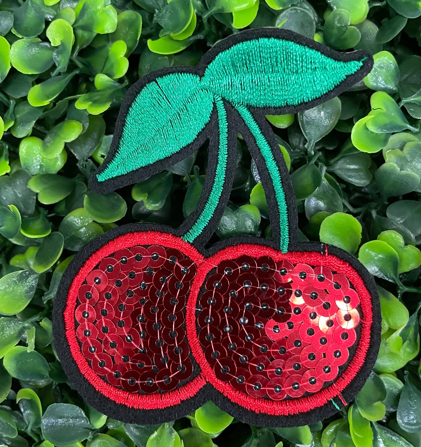 a Sequins cherry patch with a leafy backdrop 