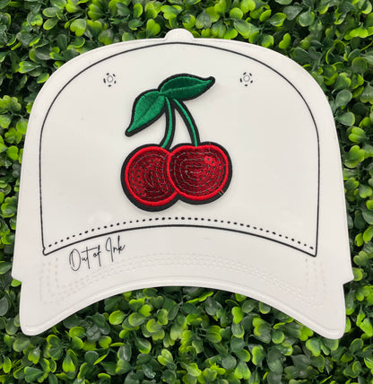 Sequins cherry patch with a leafy backdrop on a white hat template