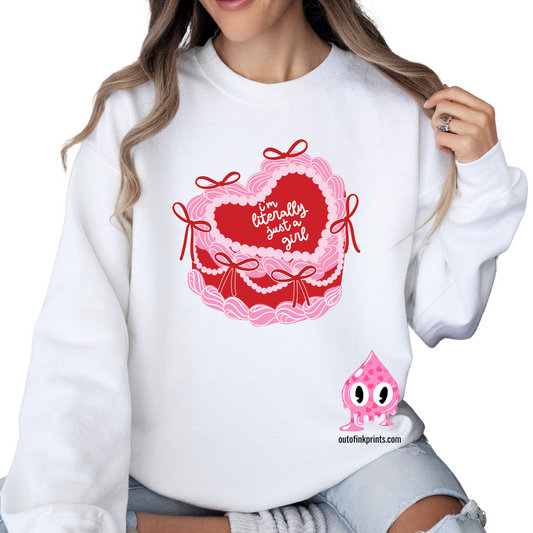 A woman sitting and wearing a white sweatshirt with a pink heart and text 'I'm Literally Just a Girl', alongside a graphic of a cake.