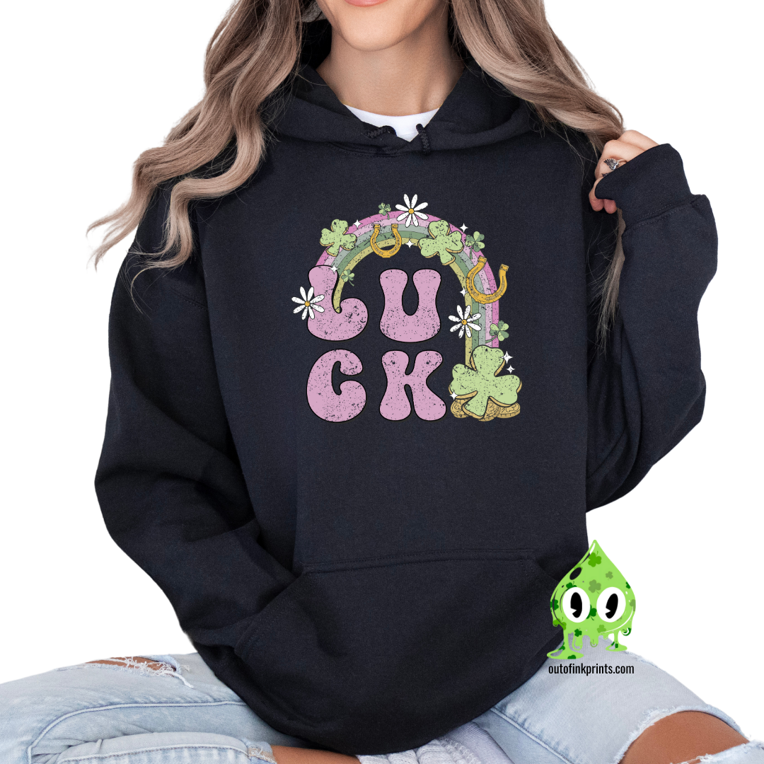 Front view of a black hoodie with a graphic print that includes the word 'LUCK' and elements representing Irish culture, such as shamrocks and gold.