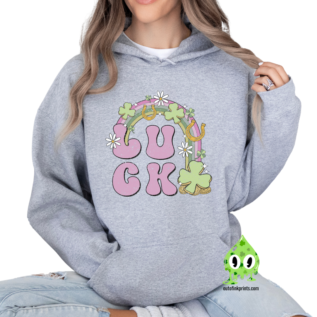 Front view of a gray hoodie with a graphic print that includes the word 'LUCK' and elements representing Irish culture, such as shamrocks and gold.