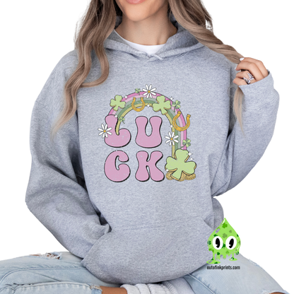 Front view of a gray hoodie with a graphic print that includes the word 'LUCK' and elements representing Irish culture, such as shamrocks and gold.