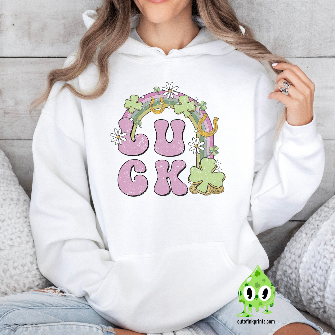 Front view of a white hoodie with a graphic print that includes the word 'LUCK' and elements representing Irish culture, such as shamrocks and gold.