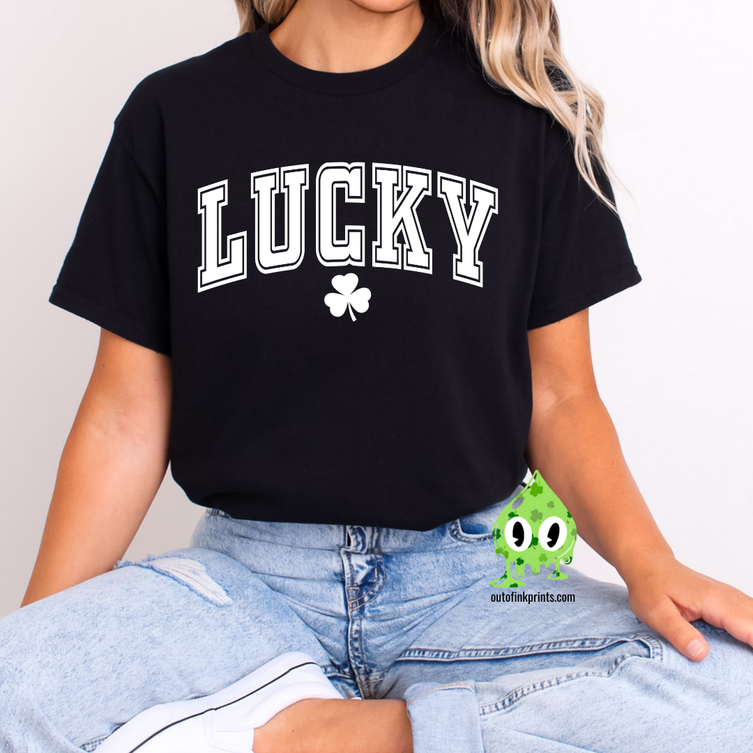 A woman wearing a black LUCKY Clover T-shirt with a shamrock graphic.