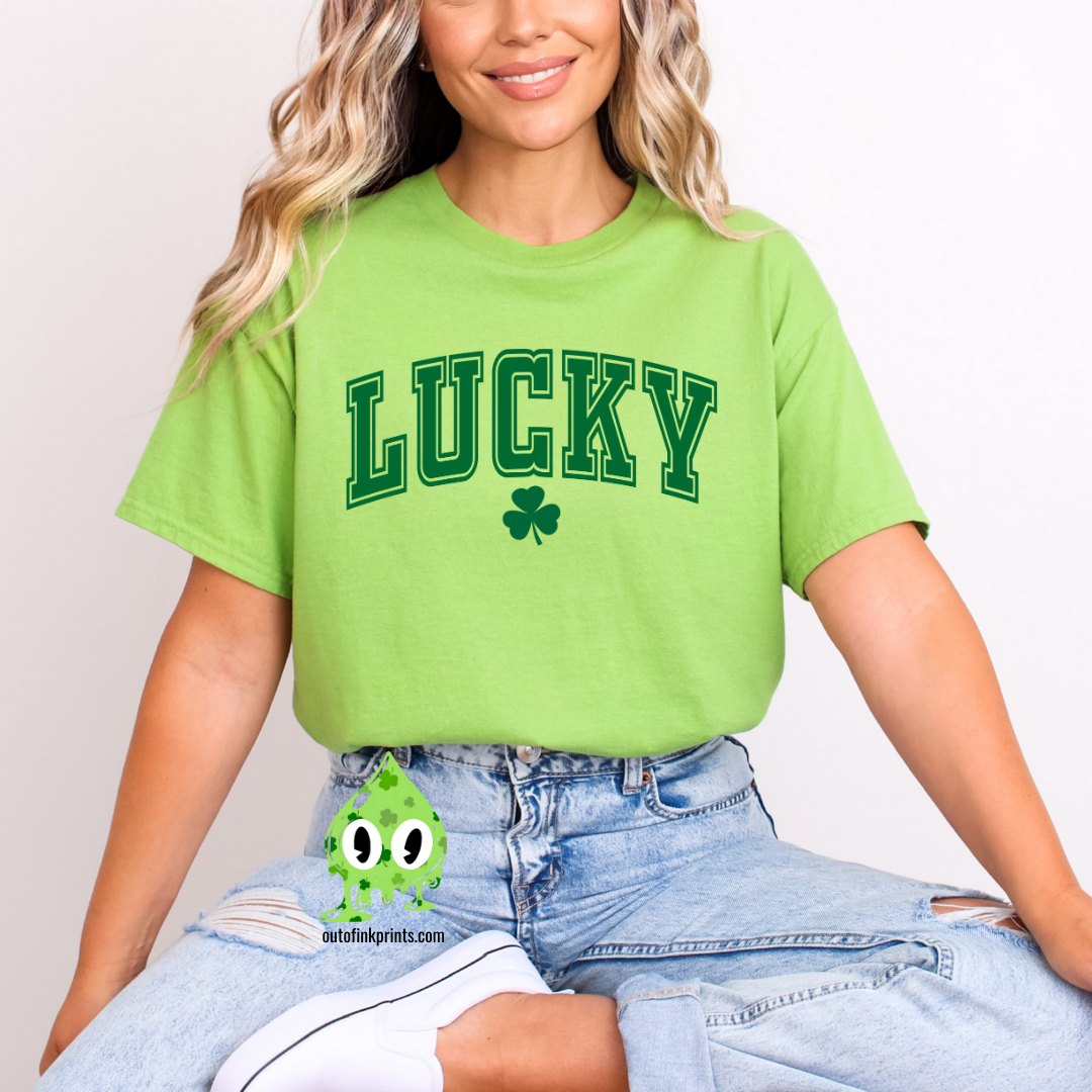 A woman wearing a green LUCKY Clover T-shirt with a shamrock graphic.