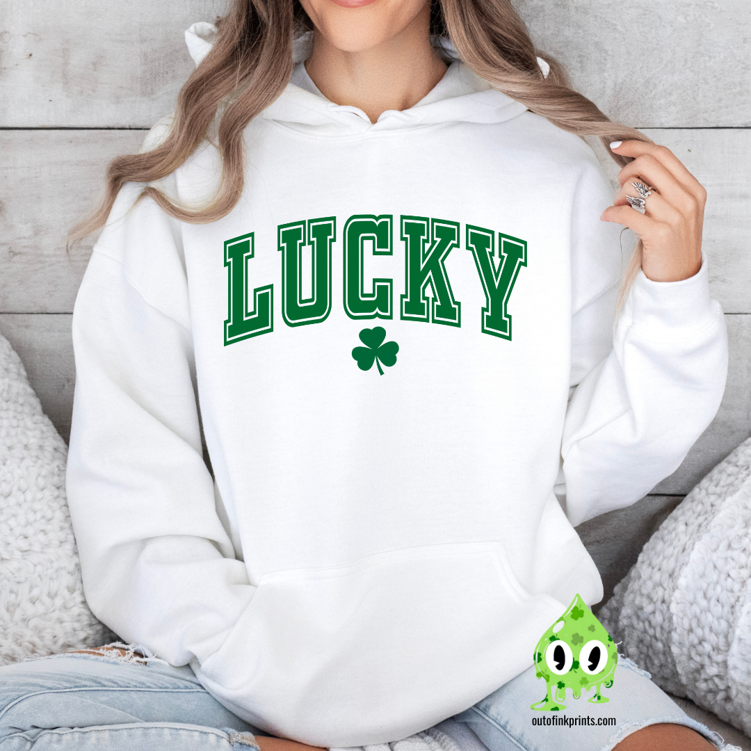 A white hoodie with the text 'LUCKY' and a clover leaf printed above the text.