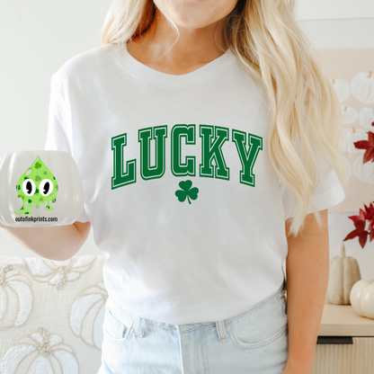 A woman wearing a white LUCKY Clover T-shirt with a shamrock graphic.