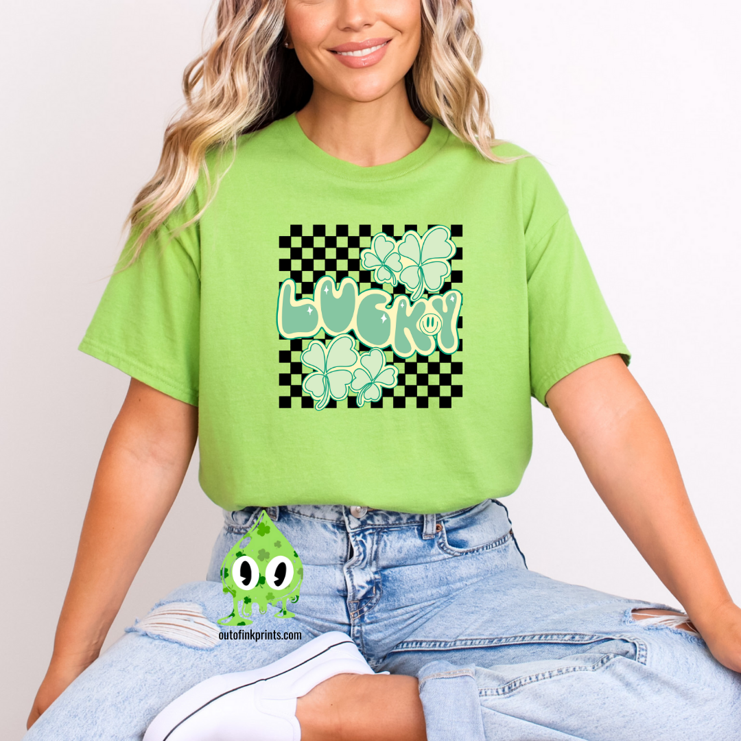 A person wearing a green 'Lucky Checkered' T-shirt with a checkered pattern and green shamrock graphics, accompanied by the text 'LUCKY!' displayed prominently.
