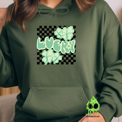 Front view of a green hoodie with a checkered pattern and a graphic that includes the text 'LUCKY' and clover designs in green.