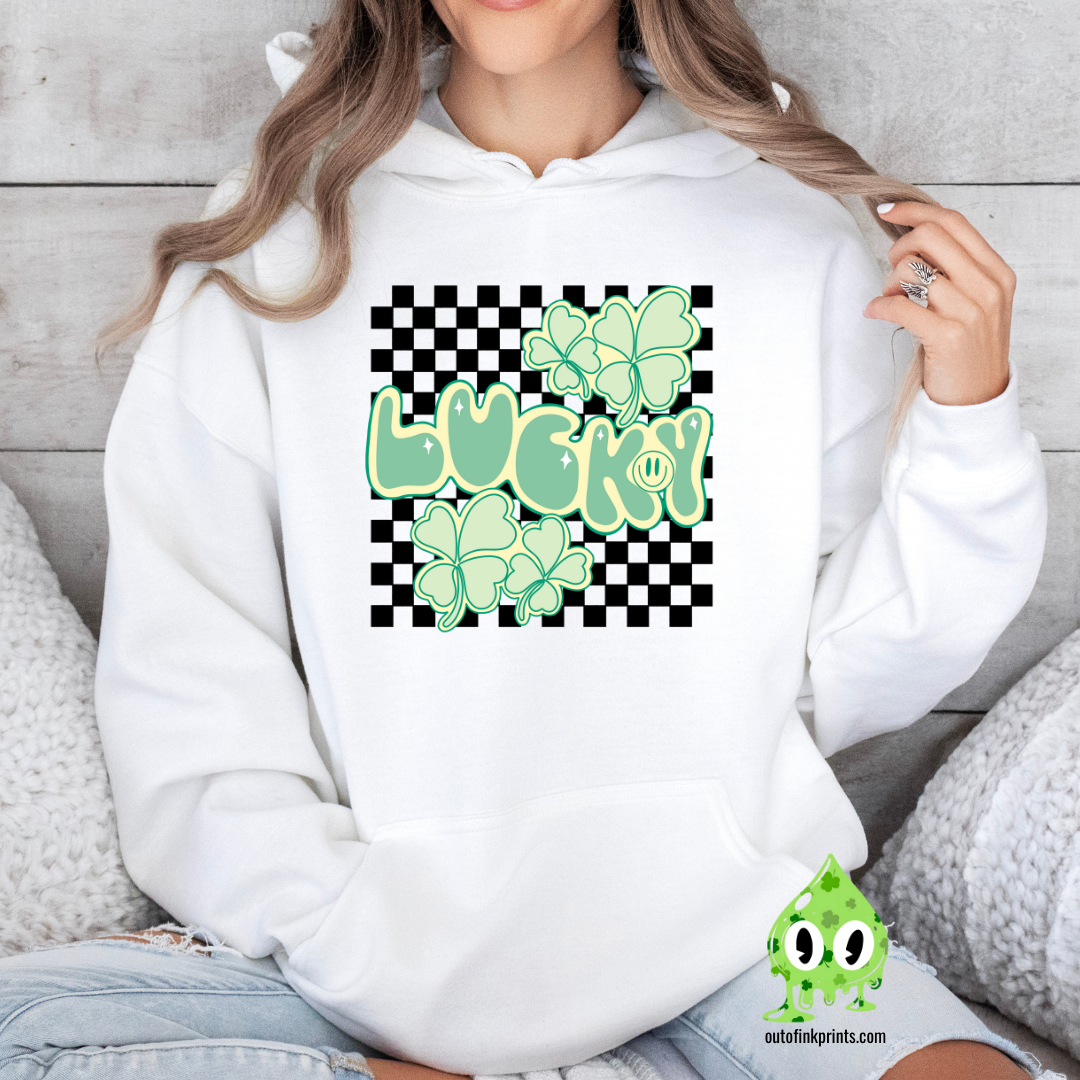 Front view of a white hoodie with a checkered pattern and a graphic that includes the text 'LUCKY' and clover designs in green.