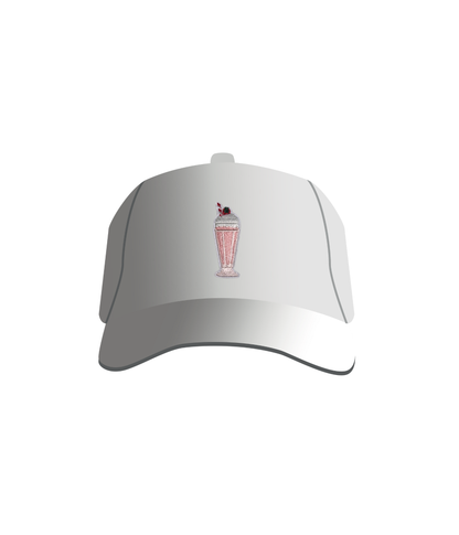 A white baseball cap with a pink milkshake embroidered patch on the front.