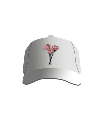A white baseball cap with a patch of embroidered pink roses on the front.