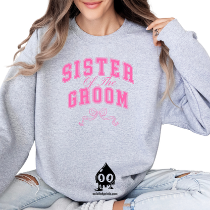 A woman wearing a gray sweatshirt with 'Sister of the Groom' text and a pink bow design on it.
