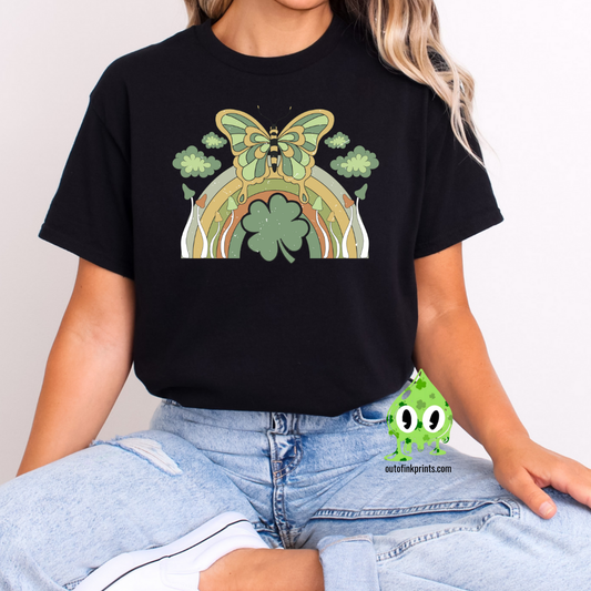 Front view of a black t-shirt with a graphic design of a butterfly and rainbows, predominantly in green color, celebrating St. Patrick's Day.
