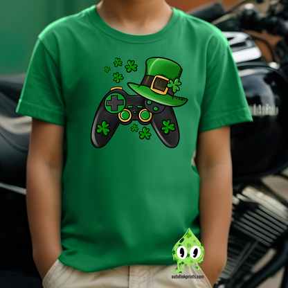 Green t-shirt with a graphic design of a video game controller and shamrocks, indicative of St. Patrick's Day themes.