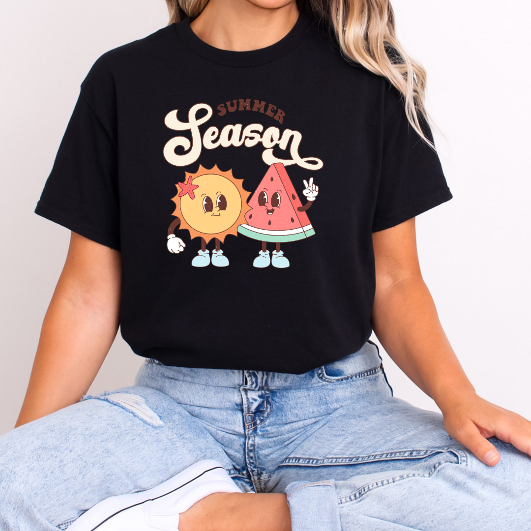 Front view of a black t-shirt with a graphic print of a sun and a watermelon, and the text 'SUMMER SEASON'.