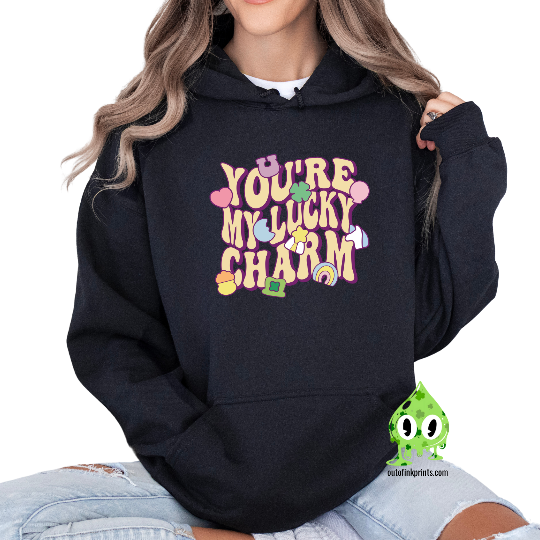 Black hoodie with 'YOU'RE MY LUCKY CHARM' text and clover graphics printed on the front.