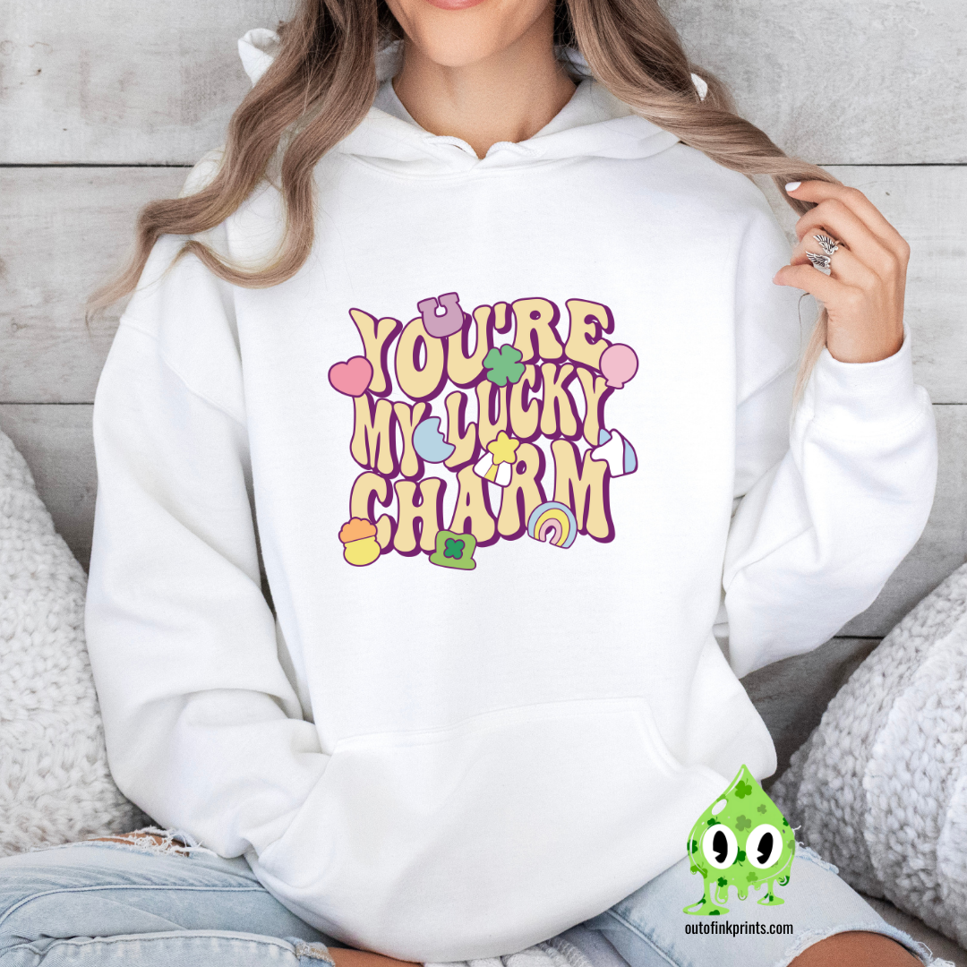 White hoodie with 'YOU'RE MY LUCKY CHARM' text and clover graphics printed on the front.