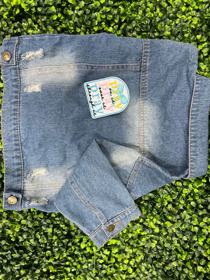Embroidered patch with 'pray on it, pray over it, pray through it' text in various colors placed on a children's denim jean jacket