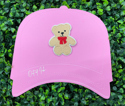 Embroidered Teddy Bear patch with a red bow set on a pink hat